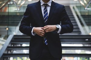 Person in a suit and tie preparing for public speaking