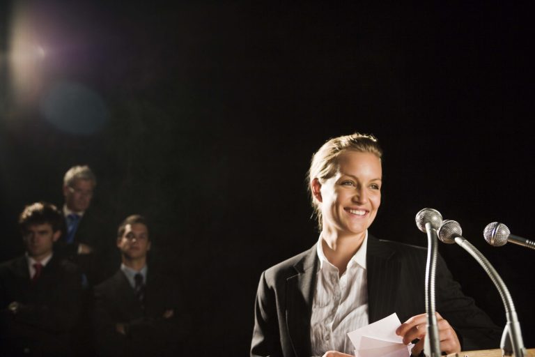 Woman with microphones and speech notes