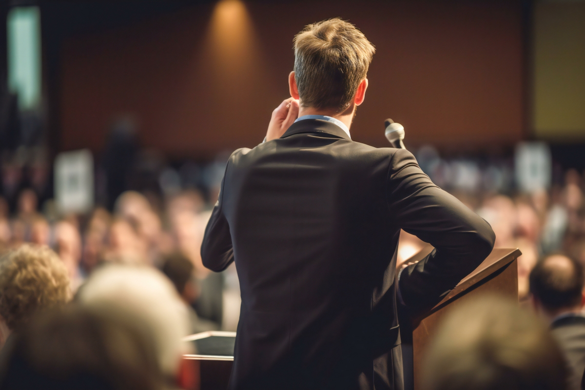 Public speaker on stage giving speech