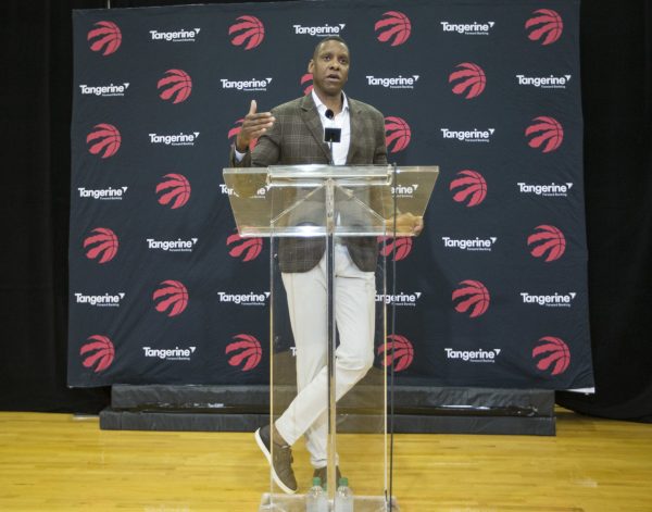 Toronto Raptors President Masai Ujiri, giving a speech behind an acrylic lectern.