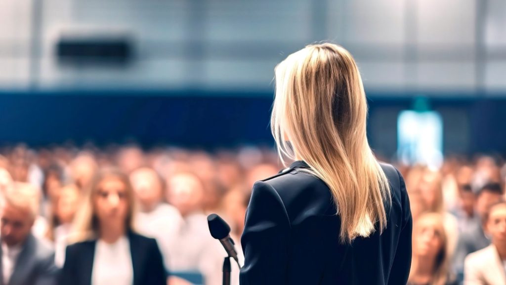 public speaker delivering a speech at a lectern