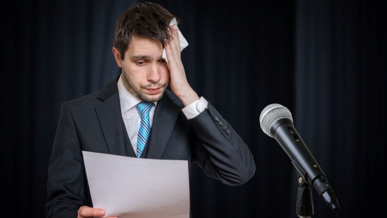 public speaker sweating because he's nervous.