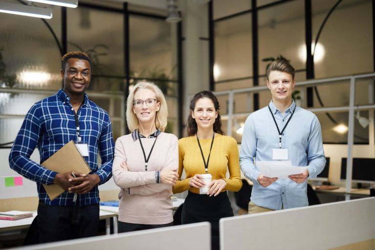 Conference planners standing in office holding supplies