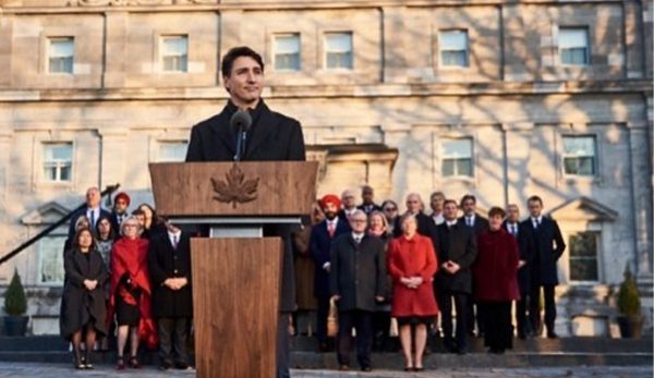 Justin Trudeau standing behind customized wood lectern