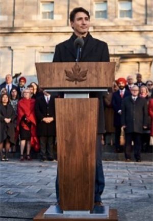 Asset-78@3xs-100.jpg Justin Trudeau speaking behind a customized wood lectern