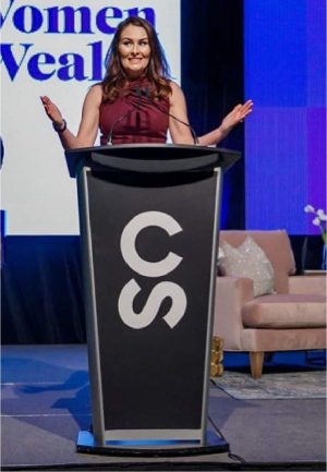 woman giving speech behind an aluminum lectern by Podium Pros